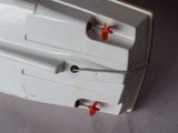 two white sinks with red handles on a white table