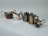 five different types of teapots on a white surface