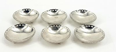 six silver plated bowls on a white surface with a white background