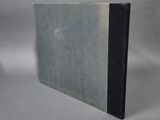 a book with a black cover sitting on top of a table