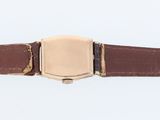 brown leather watch strap with gold buckle on a white background