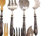 several spoons, forks, and spoons are arranged on a white surface
