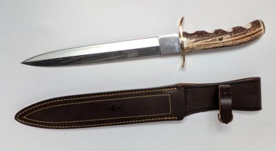 a knife that is laying on top of a leather sheath