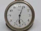 a small silver pocket watch with roman numerals on the face
