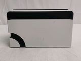 an image of a white box with a black lid on a white surface