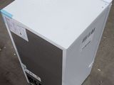 an image of a white refrigerator sitting on the ground