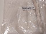 a white shirt wrapped in plastic on a table