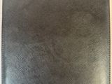 a close up of a black leather ipad case on a table