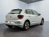 the rear end of a white volkswagen vw polo parked in a garage