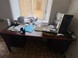 a desk with a computer and a monitor on it