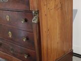 a wooden chest of drawers with a marble top