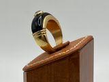 an image of a gold ring with a black stone on it