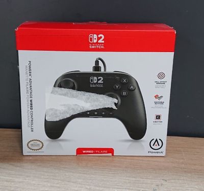 the box of a game controller sitting on top of a wooden table