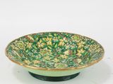 an image of a green and yellow bowl with flowers on it