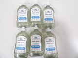 six bottles of hand sanitizer sitting on top of a white counter