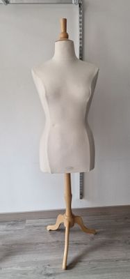 a mannequin on a wooden stand in a room