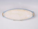 blue and white oval platter with handles on a white surface