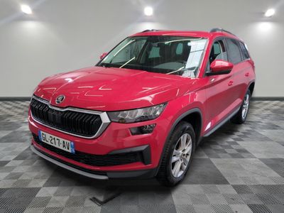 la voiture rouge est garée sur un sol en damier dans le garage