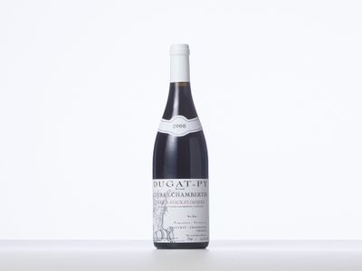 a bottle of red wine sitting on a table