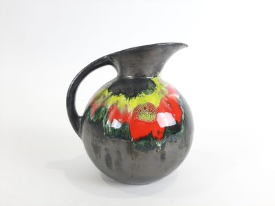 un vase noir orné d'un motif rouge et vert