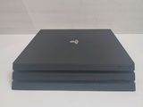 a black laptop sitting on top of a white table