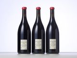 three bottles of wine sitting on top of a table next to each other