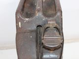 a rusted metal object on a table with a white background