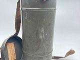 an old tin can with a brown cord on it