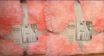 several pink and white teddy bears are on display in a store