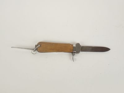 a small knife with a wooden handle on a white surface