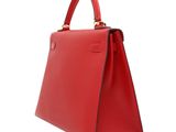 a red leather handbag on a white background