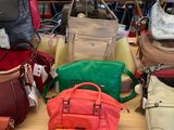 a lot of purses on a table in a store