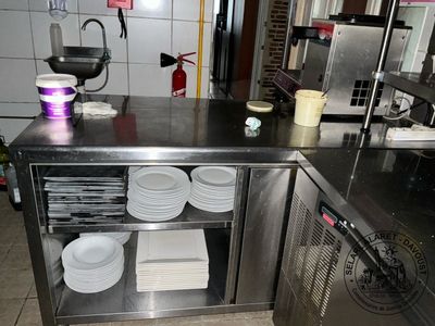a stainless steel counter with plates on it in a kitchen