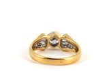 a close up of a gold ring with two diamonds on it