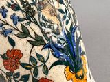 a vase with a floral design on it on a table