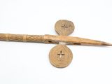 an image of a wooden stick with a cross and a button on it
