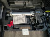 a tool in the trunk of a car that is packed with tools