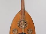 a wooden instrument hanging from a string on a wall