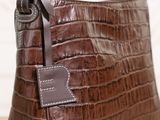 a close up of a purse with a tag on it