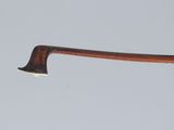 the handle of an old wooden stick with a small tooth sticking out of it