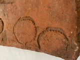 a piece of brick with writing on it on a white surface
