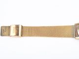 a close up of a watch on a white surface with a white background