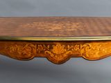 an image of a small table with a wooden top and gold decoration