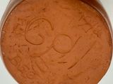someone is drawing a face on the bottom of a bowl of chocolate