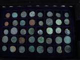 a black box filled with lots of different types of coins