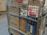 a metal cart with many items in it in a warehouse