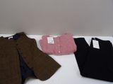 three pieces of clothing sitting on a white table