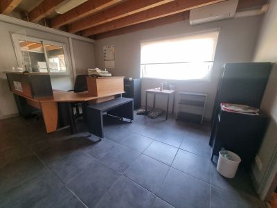 an image of a kitchen with a table and a refrigerator