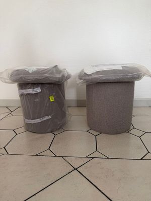 two trash cans sitting next to each other on the floor