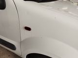 a white van with a red door and a black handle
